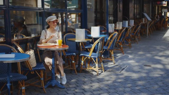 Smiling young girl in a street cafe in Paris