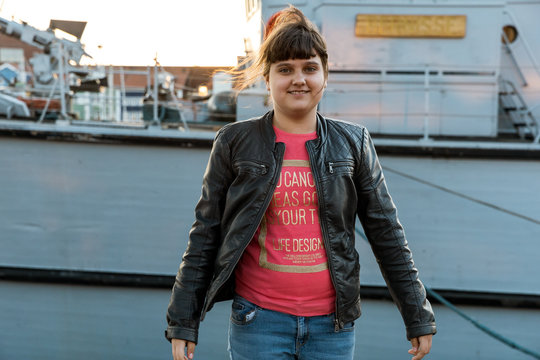 A beautiful caucasian girl standing in harbour in Hellevoetsluis, the Netherlands