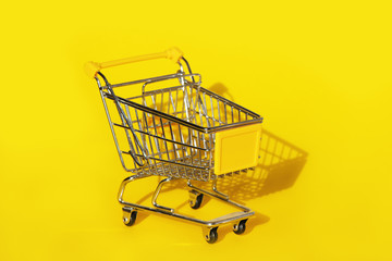Shopping cart on yellow background.