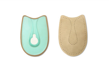Orthopedic leather heel pad from corns for the correction of different lengths of legs isolated on white background. Leather insert for the forefoot. Medical insoles. Flat Feet Correction.
