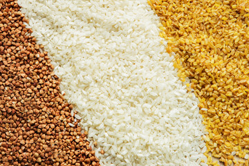 buckwheat, rice, bulgur scattered on the table