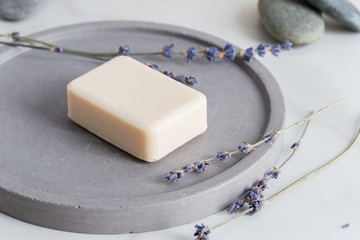 Minimal picture with sanitize soap for hand with lavender flowers at stone dish on white background.