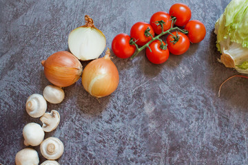 Composition with fresh vegetables on grey background, space for text.