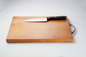 Knife on chopping board isolated over white background