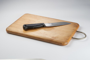 Knife on chopping board isolated over white background