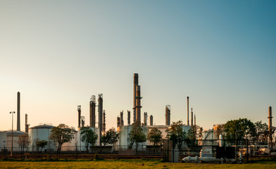 Fototapeta na wymiar Industrial landscape, factory building in the Netherlands. Heavy industry in Europe, petrochemical industrial plant power station at sunset, pollution from smokestacks, ecology problems.
