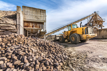 Quarry aggregate with heavy duty machinery.