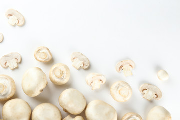 Bunch of farm raised organic mushrooms laid in composition on textured background. Champignons on table counter. Clean eating concept. Background, close up, flat lay, top view.