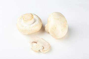 Bunch of farm raised organic mushrooms laid in composition on textured background. Champignons on table counter. Clean eating concept. Background, close up, flat lay, top view.