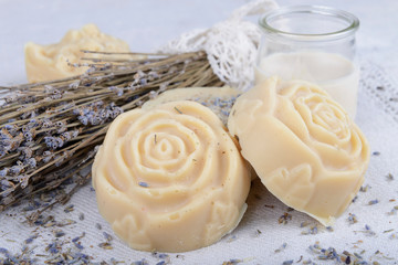 handmade soap in the shape of a rose on a white tablecloth - 341632025