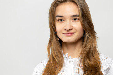 Fototapeta premium Beautiful young woman portrait. Studio shot, isolated on gray background