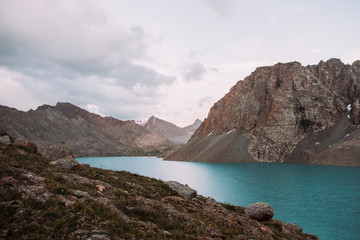 Fototapeta na wymiar Kyrgyzstan. Alakel Lake. The mountain lake is bruise in the midst of high mountains.