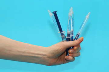 Syringes in female hand