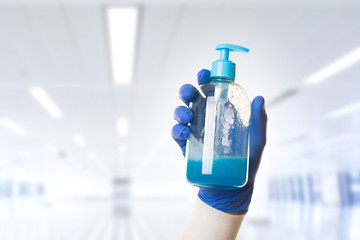 hydro alcoholic soap in diffuser boat on hands with blue gloves
