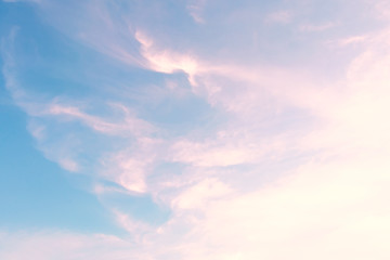 Blue sky with clouds in the form of pink streaks. Concept landscape, abstraction.