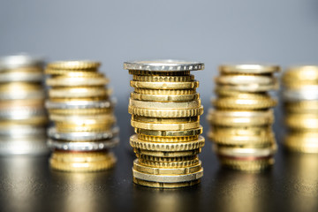 Stacks of euro coins on black table