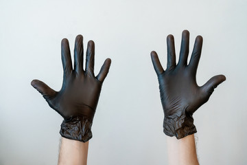 Hands in black medical gloves