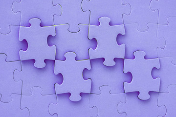 Close up of purple jigsaw puzzle background