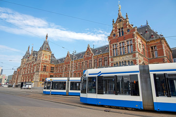 Fototapeta premium Trams at the central station in Amsterdam Netherlands