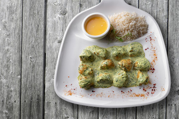 Chicken fillet in rice sauce on a white plate