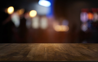 Empty dark wooden table in front of abstract blurred bokeh background of restaurant . can be used for display or montage your products.Mock up for space.