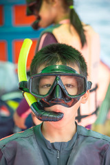 Portrait  Asian Boy wearing a life jacket and scuba diving