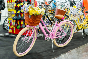 Bright city bike with basket and flowers