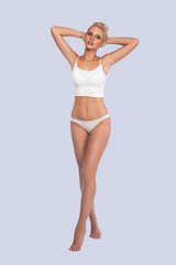 Young, slim, healthy and beautiful blonde woman in white lingerie. Sport, fitness, diet, weight loss and healthcare concept. Mockup.