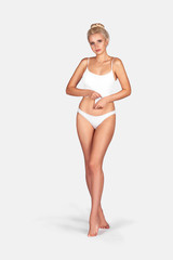 Young, slim, healthy and beautiful blonde woman in white lingerie. Sport, fitness, diet, weight loss and healthcare concept. Mockup.