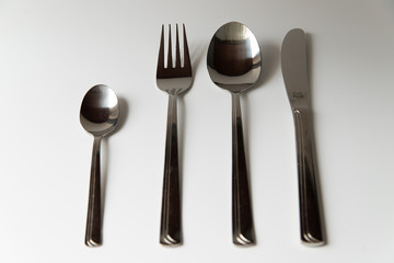 Silver fork spoon and knife on a white background