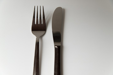 Silver fork and knife on a white background