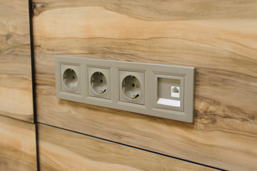 Plug Into Electricity Socket the power outlets on the wooden wall