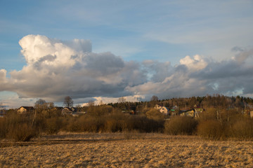 Fototapeta premium View of village from field of Klin-Dmitrovsky ridge in early spring, Sergiev Posad District, Moscow Region, Russia