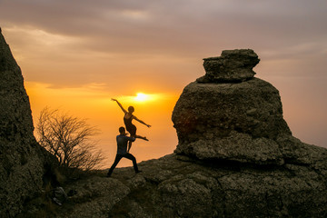 silhouette of a man and woman on a mountain top