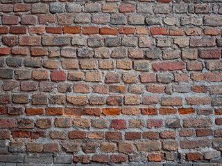 Detail of a medieval castle brickwall, dark red hues