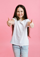 Portrait of adorable smiling little girl child in the white t-shirt with two fingers up isolated on...