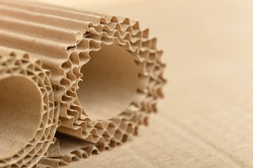 Carton or cardboard packing material. Texture of corrugated paper sheets made from cellulose. Supplies for creating boxes and packaging. Pasteboard background. Natural brown cardboard surface. - obrazy, fototapety, plakaty