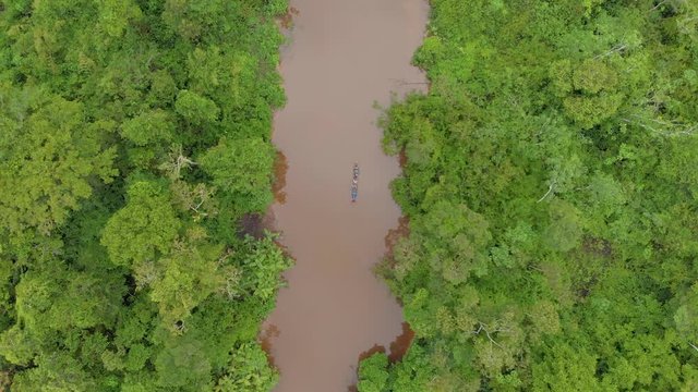 Amazon jungle, canoe in middle of the river, cenital shot, panoramic view of the amazon forest.