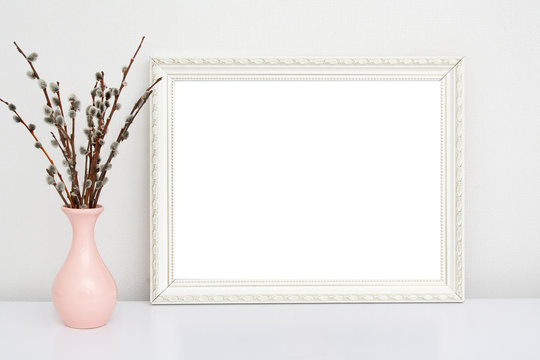 White vintage frame mock-up with pink vase with willow on a white table