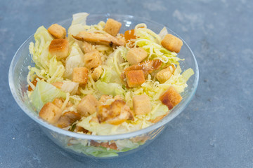 Caesar salad with toast, lettuce and grilled chicken breast and cheese