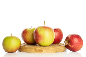 Group of five whole fresh garden apple on wooden plate isolated on white
