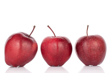 Group of three whole red delicious apple isolated on white