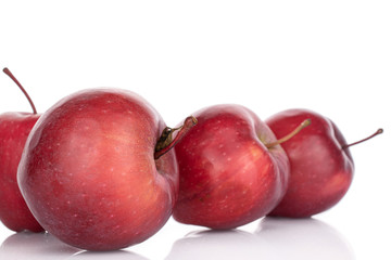 Group of four whole red delicious apple isolated on white