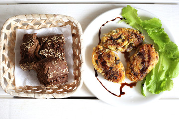 Vegan vegetable cutlets with brown rye bread.