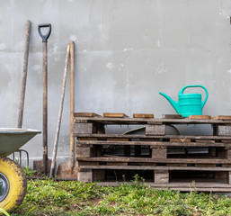 composition: vegetable garden. working tools, cart, pallets and watering can