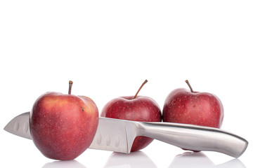 Group of three whole red delicious apple with santoku knife isolated on white