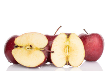 Group of three whole two halves of red delicious apple isolated on white