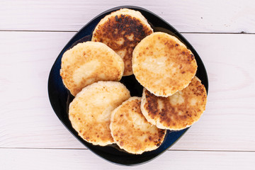 Group of six whole cheese pancake on white wood