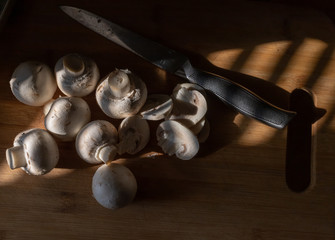 mushrooms lie on a wooden Board, warmly illuminated by a beautiful warm light.