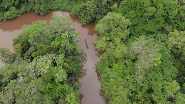 amazon jungle, canoe crossing the river, aerial view, goin down
